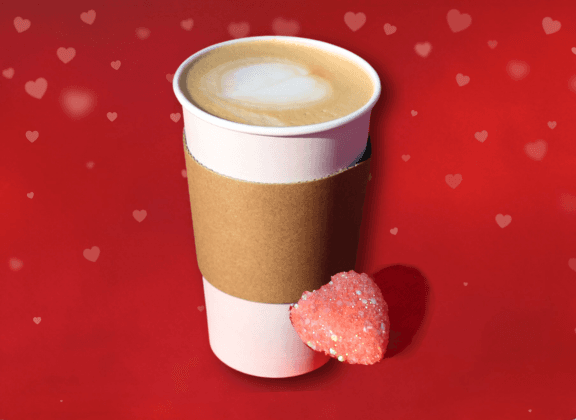 Latte with red background and a heart next to it